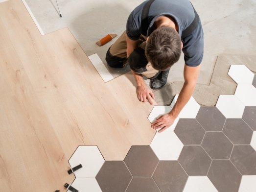 Flooring professional installing a honeycomb tile floor