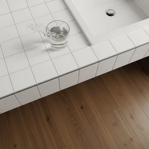Wood look waterproof flooring in a bathroom with white tile counters
